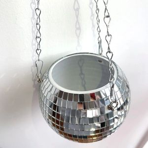 Detailed view of shiny mirror disco ball hanging planter with silver chains and hooks