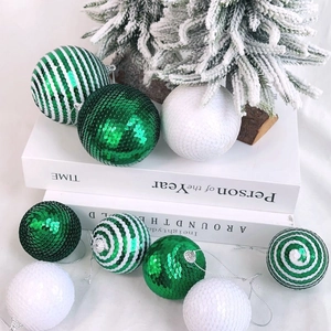 Detail of Christmas sequin balls in green and white stripes for holiday tree decoration