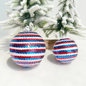 Close-up of red, white and blue sequined patriotic balls with silver caps and ropes