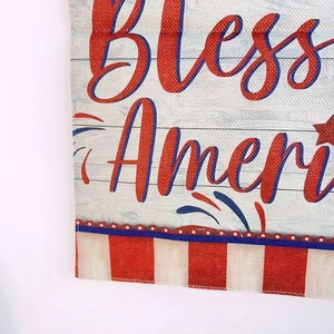 Detail of linen garden flag showing American flag stripes and red script lettering