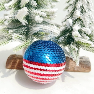 Detail of USA Independence Day sequin ball with red white and blue stripes and silver loop