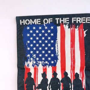 Detail view of linen garden flag with American flag pattern and Home of the Free text