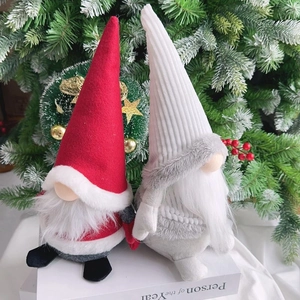 Detail of Christmas faceless gnome dolls featuring plush beards and pointed hats on tree