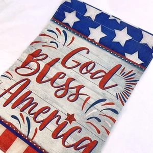 Detail of God Bless America garden flag with linen texture and rustic burlap fabric