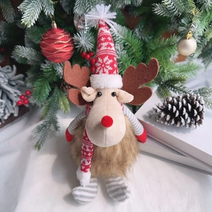 Close-up of plush Christmas reindeer with snowflake knit hat and striped legs