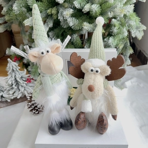Detail showing two plush Christmas reindeer figurines in mint green and festive hats