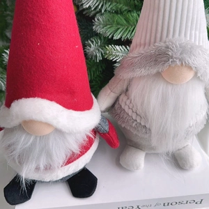 Close-up of handmade Christmas gnome dolls with plush beards and knitted hats for festive decor