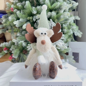 Close-up of 35cm Christmas reindeer doll with mint green knit hat and brown leather boots