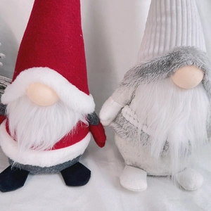 Detail of red and grey Christmas gnomes with knit hats and long white beards