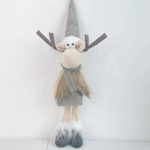Cute Christmas reindeer plush toy with grey knit hat and scarf on white background