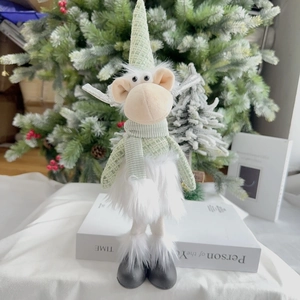 Detail of a 35cm mint green Christmas reindeer plush toy with knitted hat and fur skirt