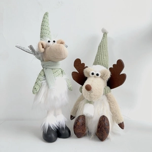 Detail of plush Christmas reindeer dolls in mint green and white with knitted accents