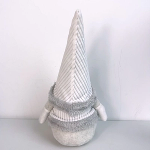 Close-up of a Nordic Christmas gnome with a striped hat and soft white plush beard
