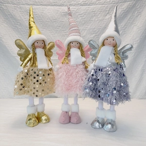 Close-up of three long-legged angel dolls in gold, pink and silver with plush wings