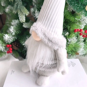 Detail of a Christmas faceless gnome with white knitted hat and gray plush fur texture