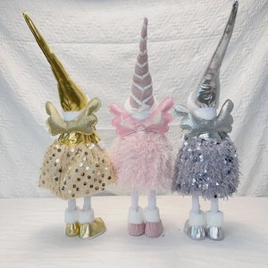 Three long-legged angel dolls with pointed hats and wings in gold, pink, and silver