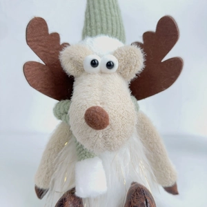Close-up of a Christmas elk plush toy with green knit hat and white faux fur body