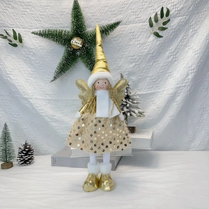 Detail of Christmas angel doll featuring gold sequins, wings, and white plush scarf