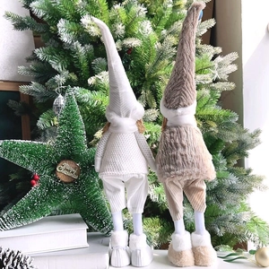 Rear view of two long-legged plush Christmas gnome dolls with tall hats and sweater texture