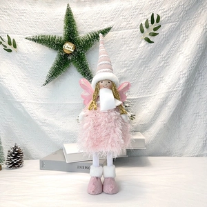 Detailed view of plush Christmas angel doll with pink knit hat and sequined wings