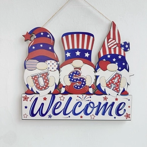 Detail of USA themed gnomes on a wooden welcome sign with Fourth of July patriotic patterns