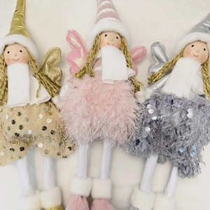 Detailed close-up of three plush angel dolls with sequin wings and knitted braids