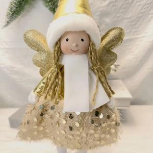 Detail showing golden sequin skirt and plush white wings of Christmas angel doll
