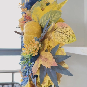 Blue and orange Halloween pumpkin wreath with faux maple leaves for autumn door decor