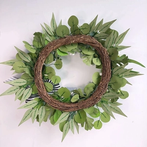 Detailed view of pumpkin wreath featuring eucalyptus leaves and a black-white striped bow