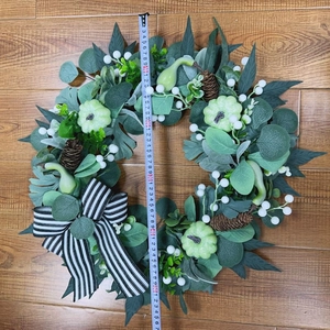Detailed view of autumn wreath with mini pumpkins and pine cones measuring 50cm in diameter