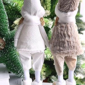 Detailed view of the cozy knitted and faux fur textures on plush holiday angel dolls