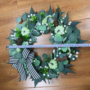 Detail of 50cm autumn wreath with mini pumpkins, pine cones, and a striped bow