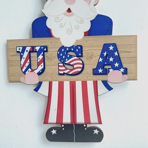 Close-up of Uncle Sam wooden door sign featuring the USA text and patriotic design