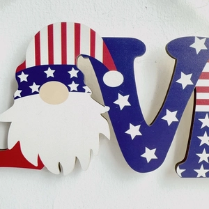 Close-up of patriotic gnome wooden sign with American flag stars and stripes pattern