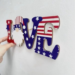 Detail of wooden LOVE sign with patriotic gnome for Independence Day wall decor