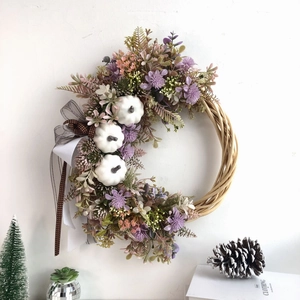 Autumn harvest wreath with white pumpkins, purple flowers, and polka dot bow on vine base