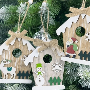 Three wooden Christmas house ornaments with Santa and reindeer on tree branch