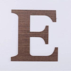 Detail of walnut wood grain texture on capital letter E wall hanging home decor
