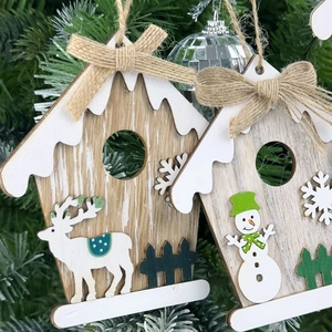 Detail of wooden Christmas house ornaments with reindeer and snowman on tree branches