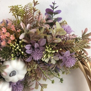 Autumn wreath featuring white pumpkins, purple thistles and greenery on rattan base