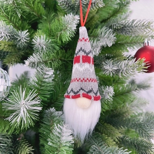 Close-up of a festive gnome Christmas tree ornament with a grey and red knitted hat