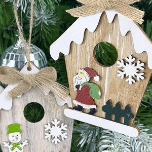 Rustic wooden Christmas house ornament with Santa and snowman on pine tree branch
