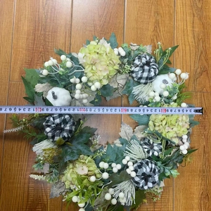 Detail view of harvest wreath diameter measurement with white pumpkins and checkered patterns