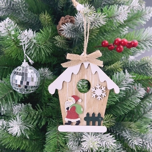 Detail of wooden birdhouse Christmas ornament with Santa Claus print on a tree branch