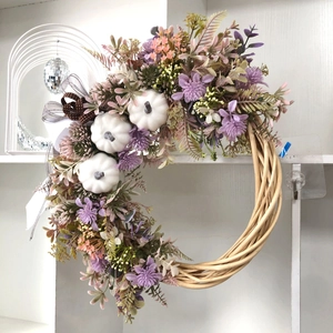 Handcrafted autumn wreath with white pumpkins, purple silk flowers and a polka dot ribbon