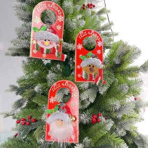 Detailed view of plush Santa, snowman, and reindeer door hangers on a festive Christmas tree