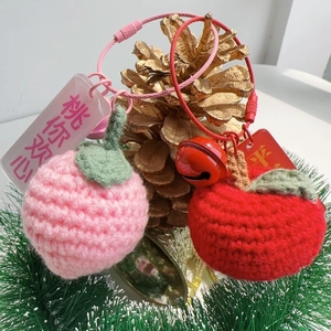 Handmade knitted peach and apple keychains with metal rings and festive decorations