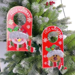 Detailed view of Christmas door hangers featuring plush reindeer and snowman decorations