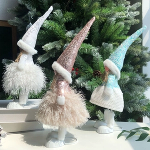 Detailed view of three glitter angel dolls with fur skirts on metal stands for Xmas