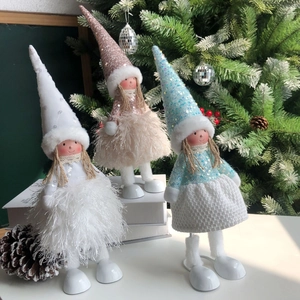 Detail view of trio plush Christmas angel dolls with sequin hats and furry skirts